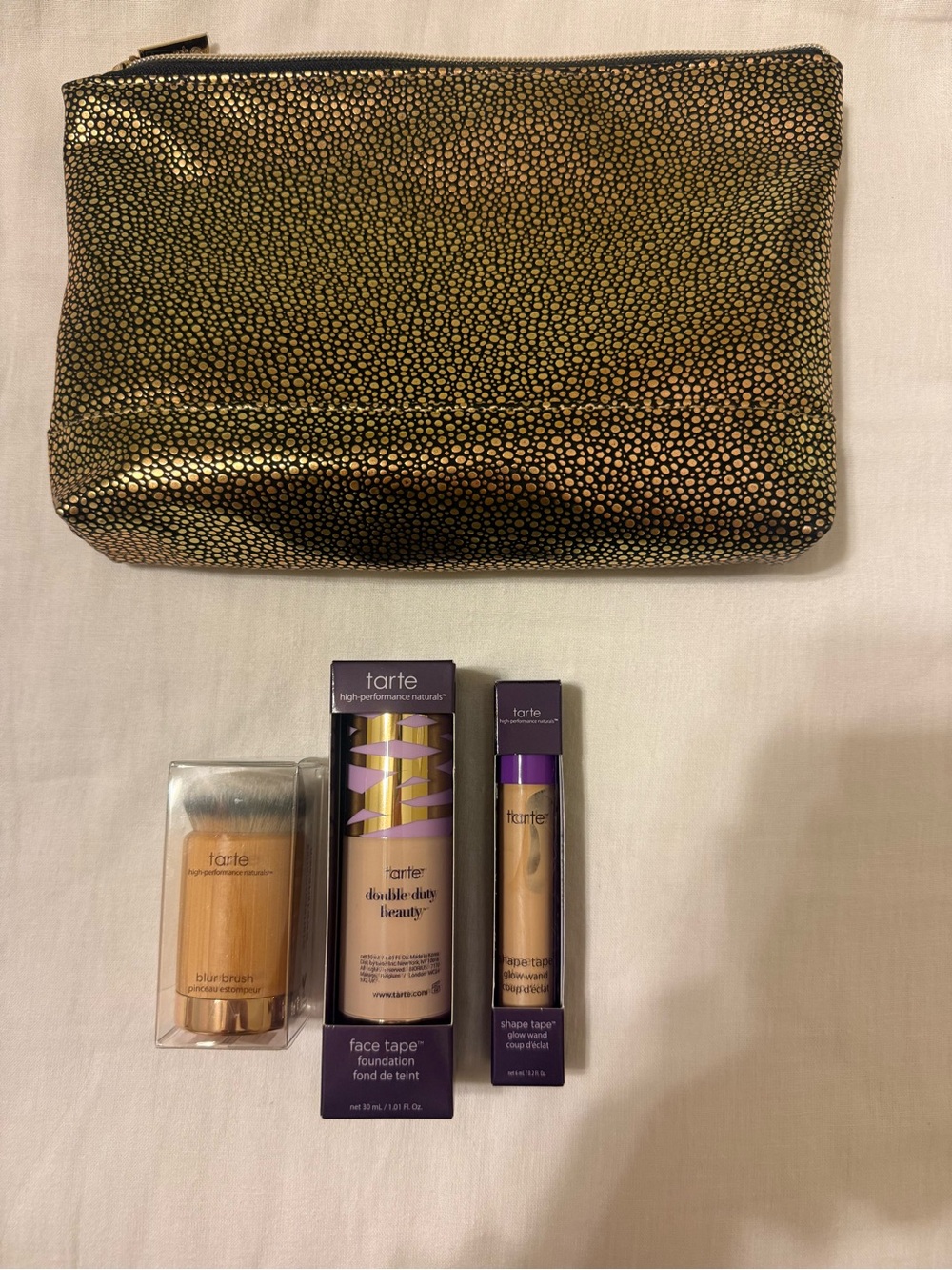 tarte makeup minis in purple packaging with gold-speckled pouch
